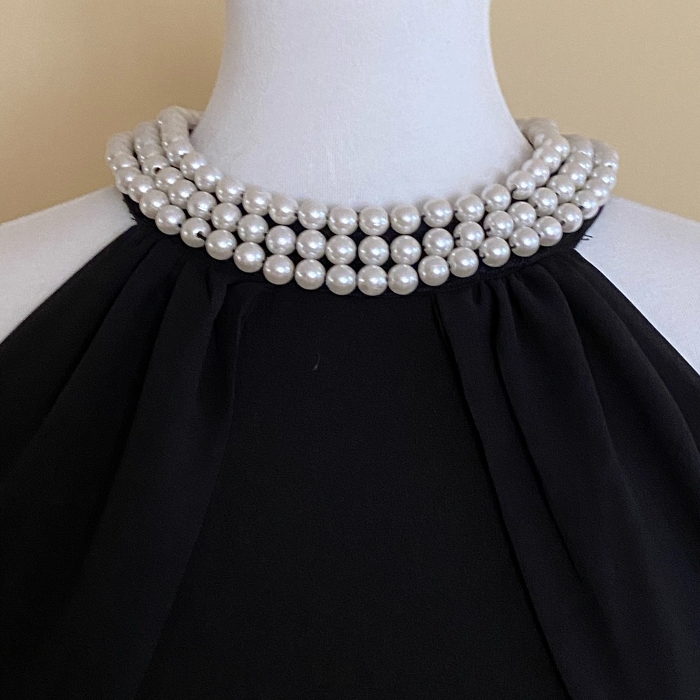Women’s lulus size small black gown with pearls on the neckline.